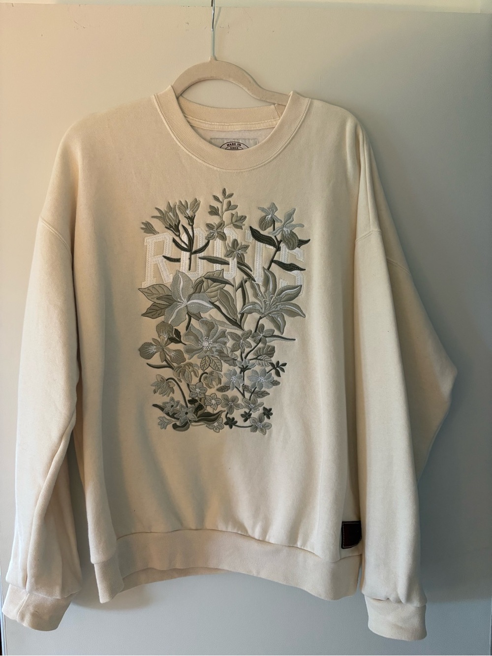 Roots Cream Crewneck Sweatshirt with Green Floral Embroidery